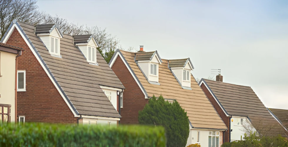 a row of house roofs with asphalt shingles