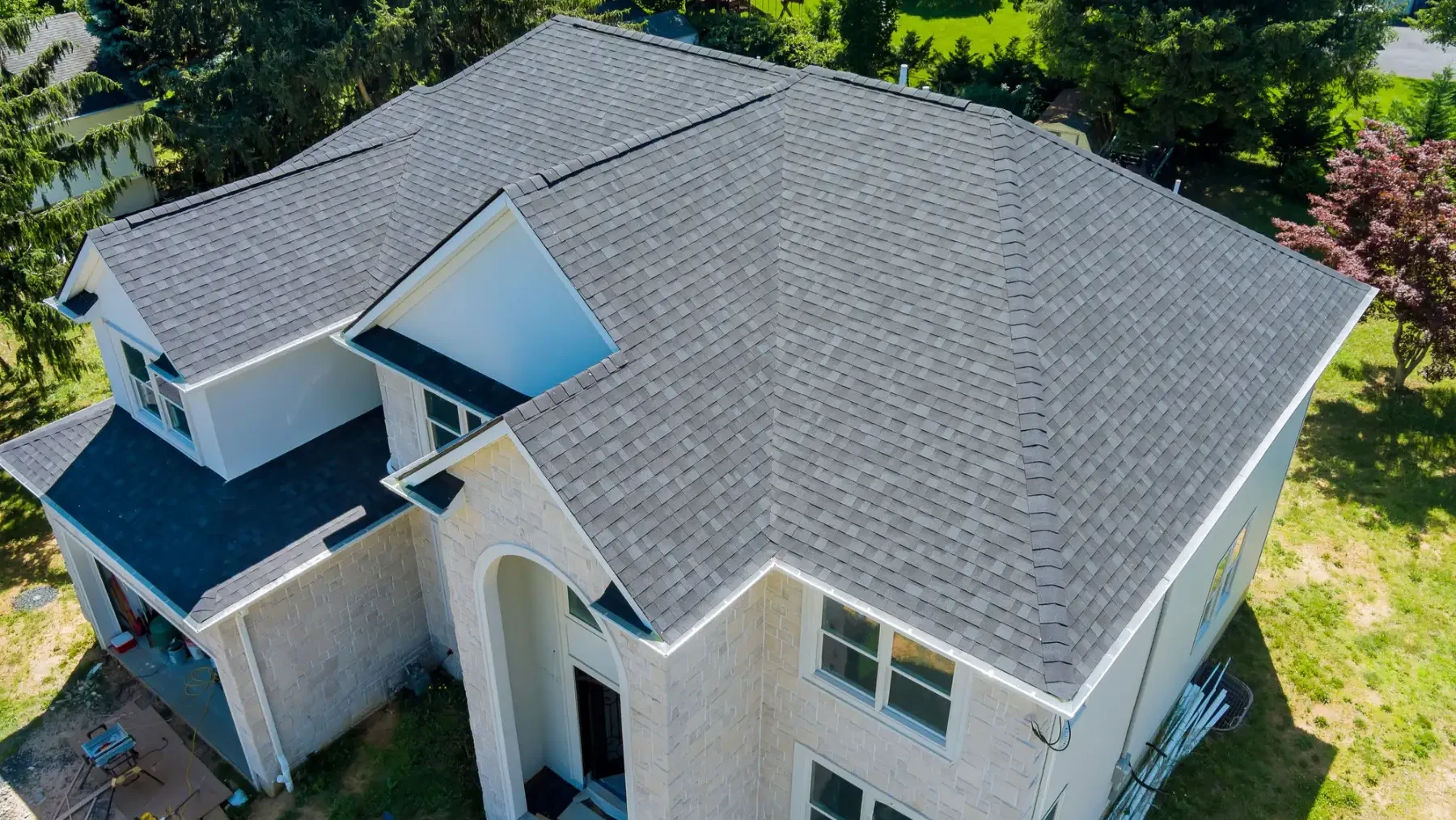 white house with a gray asphalt shingle roof