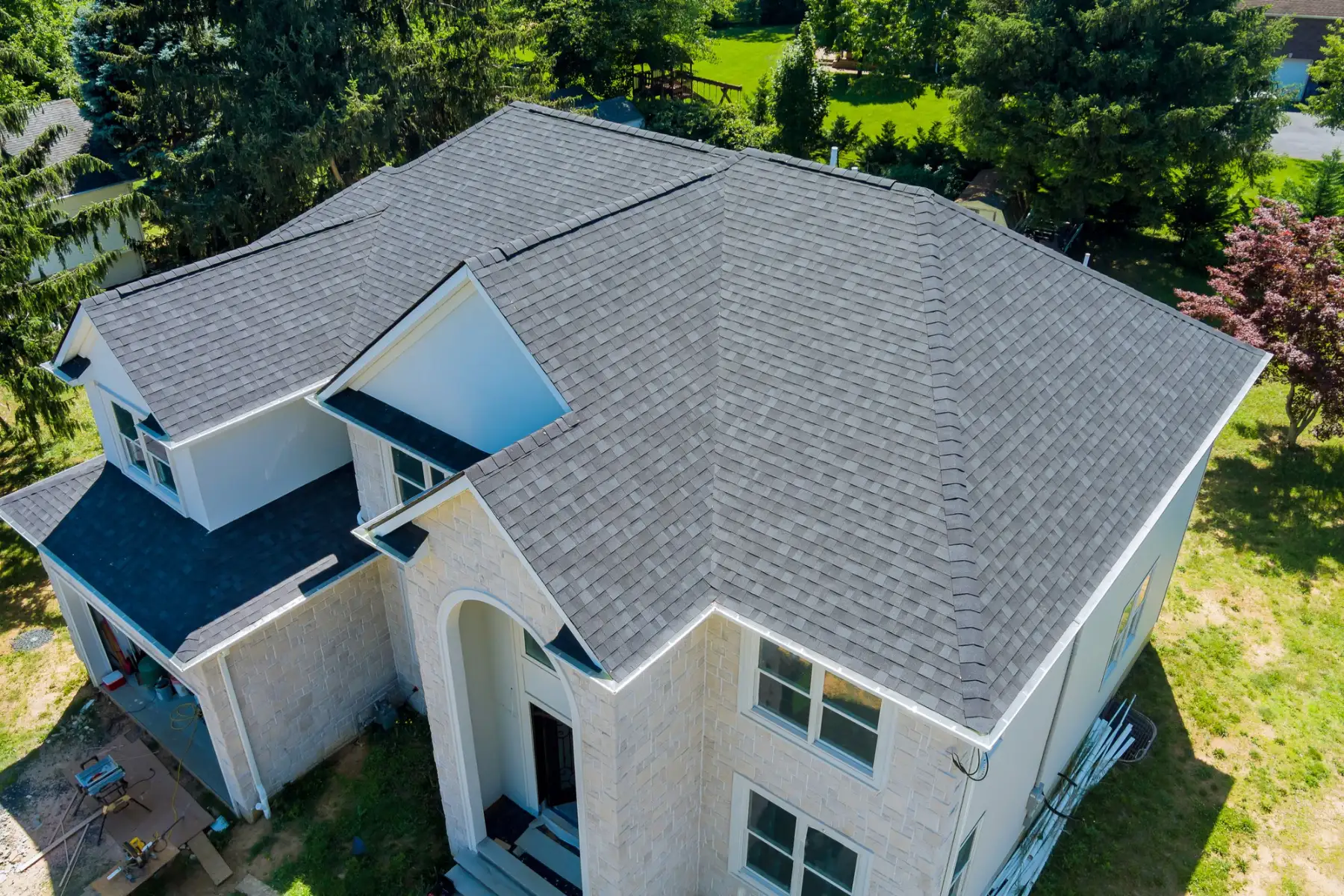 white house with a gray asphalt shingle roof