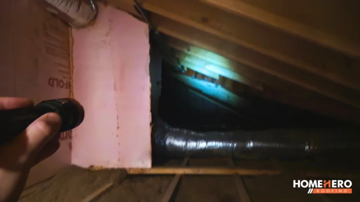 attic roof interior inspection with flashlight