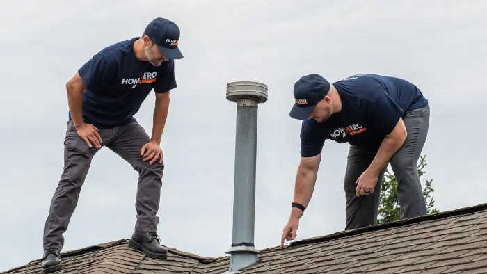 production coordinator inspecting roof peak